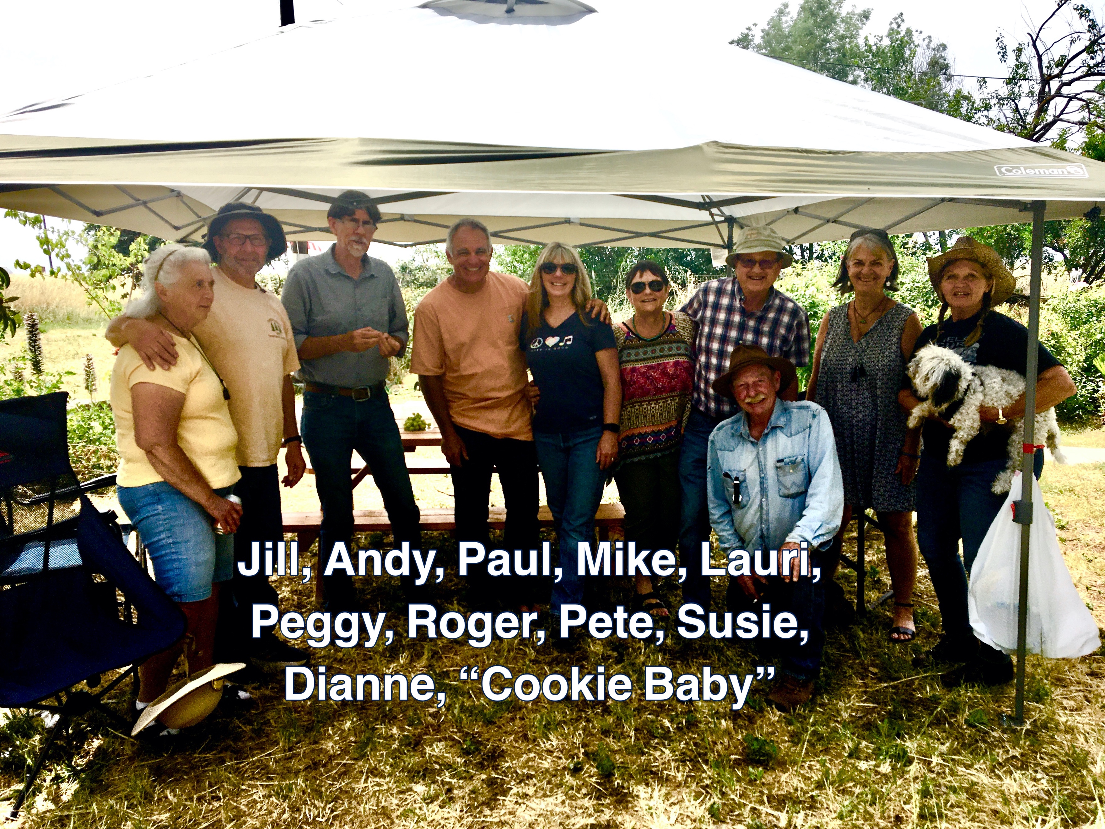 A group of people standing under a tent
Description automatically generated with medium confidence