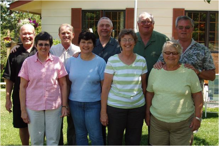 A group of older people standing together

Description automatically generated